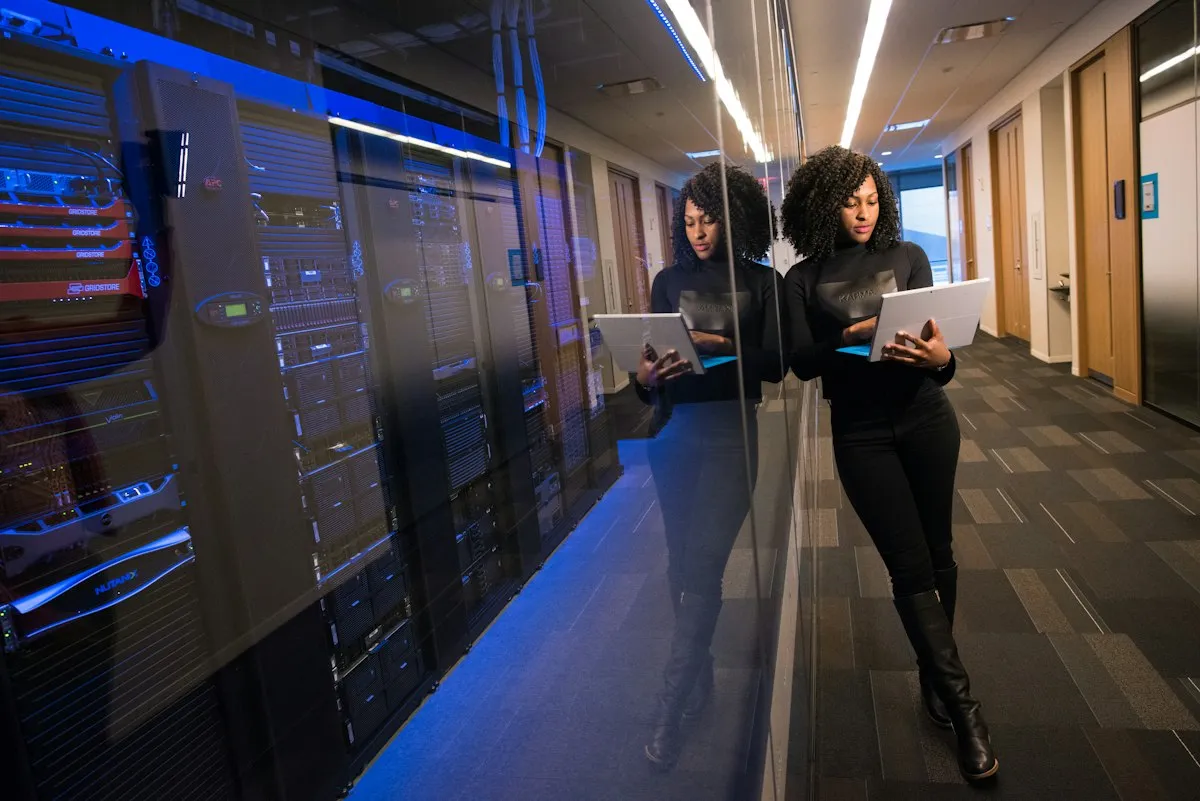 Blue-lit corridor between rows of data-center infrastructure