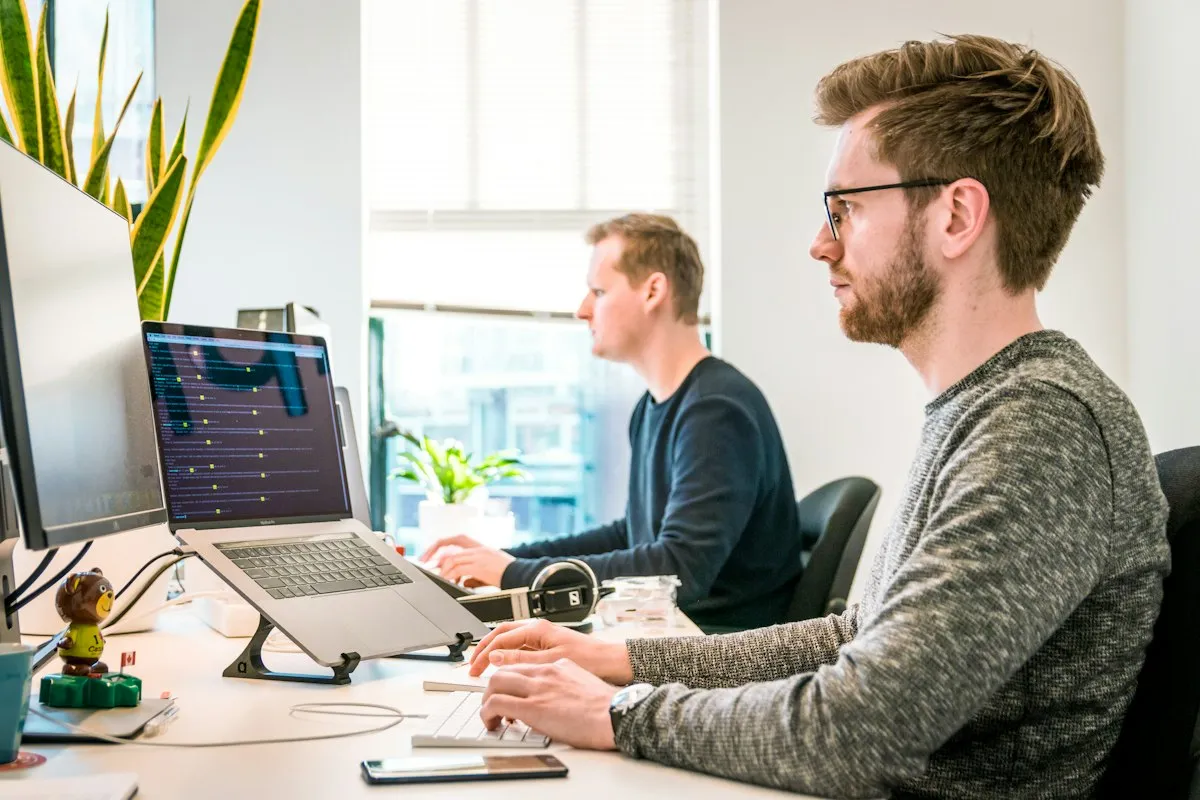Security professionals reviewing code on computer monitors