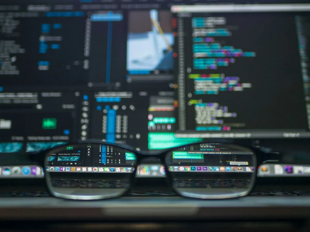 Security monitoring code displayed across multiple computer screens